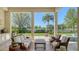 Outdoor living space featuring seating, a coffee table, and scenic views of the lake and greenery at 3153 Founders Club Dr, Sarasota, FL 34240