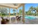 Inviting outdoor patio with a comfortable seating area, overlooking the pool and lush landscaping at 3153 Founders Club Dr, Sarasota, FL 34240