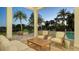 Covered patio at dusk, with seating, a coffee table, and a pool view at 3153 Founders Club Dr, Sarasota, FL 34240