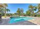 Backyard pool area with a fountain feature and lush landscaping, perfect for outdoor relaxation at 3153 Founders Club Dr, Sarasota, FL 34240