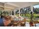 Relaxing outdoor porch with comfortable seating, ceiling fans, and views of the lush golf course at 3153 Founders Club Dr, Sarasota, FL 34240
