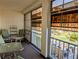 Relaxing balcony area with outdoor seating, offering serene views of the community's green spaces at 3719 Lake Bayshore Dr # H-204, Bradenton, FL 34205