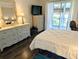 Comfortable bedroom with natural lighting, wicker furniture, and balcony access at 3719 Lake Bayshore Dr # H-204, Bradenton, FL 34205