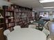 Spacious community room with tables, chairs, and bookshelves, perfect for gatherings and activities at 3719 Lake Bayshore Dr # H-204, Bradenton, FL 34205