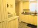 Cozy kitchen features white cabinetry, neutral countertops, and essential appliances for convenient meal preparation at 3719 Lake Bayshore Dr # H-204, Bradenton, FL 34205