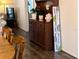Cozy living space with wood-look flooring, a welcome sign, and lots of natural light at 3719 Lake Bayshore Dr # H-204, Bradenton, FL 34205