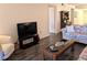 Relaxing living room featuring a TV, a coffee table, and stylish decor at 3719 Lake Bayshore Dr # H-204, Bradenton, FL 34205