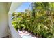 Balcony view overlooking pool and lush tropical foliage at 4002 6Th Ave, Holmes Beach, FL 34217