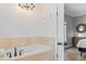 Bright bathroom with a tiled tub and a view of the bedroom at 4002 6Th Ave, Holmes Beach, FL 34217