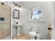 Bathroom featuring a toilet, a sink, and a shower stall at 4002 6Th Ave, Holmes Beach, FL 34217
