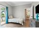 Bedroom with exterior balcony access and kitchen view at 4002 6Th Ave, Holmes Beach, FL 34217