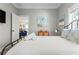 Bedroom featuring beach-themed decor, laminate flooring and natural light at 4002 6Th Ave, Holmes Beach, FL 34217