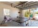 Open garage featuring a ping pong table, bicycles and storage at 4002 6Th Ave, Holmes Beach, FL 34217