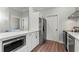 Kitchen with stainless steel appliances, white cabinets, and modern countertops at 4002 6Th Ave, Holmes Beach, FL 34217