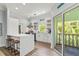 Kitchen and dining area with island seating and access to outdoor balcony at 4002 6Th Ave, Holmes Beach, FL 34217