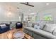 Comfortable living area with a gray sofa, a wooden coffee table, and an open view into the kitchen at 4002 6Th Ave, Holmes Beach, FL 34217