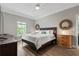 Spacious bedroom featuring a ceiling fan, wooden floors and a queen-size bed at 4002 6Th Ave, Holmes Beach, FL 34217