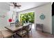 Inviting patio with a dining table, fan, and an open view to a secluded backyard with lush vegetation at 4002 6Th Ave, Holmes Beach, FL 34217