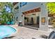 Exterior with private pool, covered dining, grill area, and lush landscaping for outdoor enjoyment at 4002 6Th Ave, Holmes Beach, FL 34217