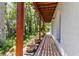 Covered walkway with exposed beam and potted plants leading to lush greenery for a peaceful outdoor experience at 4002 6Th Ave, Holmes Beach, FL 34217