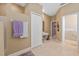 Neutral-toned bathroom featuring double doors, a built-in vanity area, and tile flooring at 4025 Giannini Ln, Sarasota, FL 34233