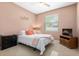 Comfortable bedroom showcasing a bright window, a ceiling fan, and a cozy color scheme at 4025 Giannini Ln, Sarasota, FL 34233