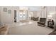 Bright and airy living room with neutral carpet, and an open layout flowing to the dining room and entryway at 4025 Giannini Ln, Sarasota, FL 34233