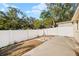 Spacious backyard with a privacy fence, lush green grass, and mature trees at 411 28Th W St, Palmetto, FL 34221