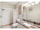 Bathroom featuring a granite vanity, framed art, and tiled walk-in shower at 411 28Th W St, Palmetto, FL 34221