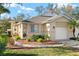 Charming single-story home with a well-manicured lawn, a two-car garage and beautiful landscaping in a warm-toned color palette at 411 28Th W St, Palmetto, FL 34221