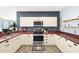 The kitchen features stainless-steel appliances, white cabinets, dark countertops and modern fixtures and hardware at 411 28Th W St, Palmetto, FL 34221