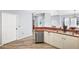 Galley kitchen featuring stainless steel appliances, wood-look flooring, and ample counter space at 411 28Th W St, Palmetto, FL 34221