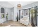 Bright living room features a bay window, modern lighting, and a contemporary chair, blending style and comfort at 411 28Th W St, Palmetto, FL 34221