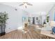 Spacious living room offering wood-style floors, a modern fireplace, and an open layout leading to the kitchen area at 411 28Th W St, Palmetto, FL 34221