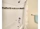 Bathtub with white tile, chrome fixtures and a shower curtain at 4307 Gulf Dr # 202, Holmes Beach, FL 34217