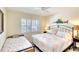 Bedroom with two beds, shutters and ceiling fan at 4307 Gulf Dr # 202, Holmes Beach, FL 34217
