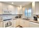 Modern kitchen featuring white cabinetry and granite countertops at 4307 Gulf Dr # 202, Holmes Beach, FL 34217