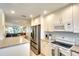 Well-lit kitchen with stainless steel appliances and granite countertops overlooks the living area at 4307 Gulf Dr # 202, Holmes Beach, FL 34217