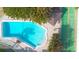 Aerial view of the community pool, shuffleboard court and shaded cabana area at 4307 Gulf Dr # 202, Holmes Beach, FL 34217