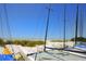 Sailboats resting on a sandy beach with views of the ocean and blue skies above at 4307 Gulf Dr # 202, Holmes Beach, FL 34217