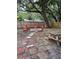 A rustic firepit and picnic table provides an area to relax in the yard at 4705 Hollingsworth Ave, Sarasota, FL 34233