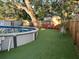This yard features a pool, artificial turf, trees and a home at 4705 Hollingsworth Ave, Sarasota, FL 34233