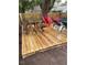 Newly constructed deck with a picnic table and red chairs near the pool and fenced in yard at 4705 Hollingsworth Ave, Sarasota, FL 34233