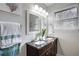 Dual sink bathroom vanity featuring granite countertop and large mirrors at 4705 Hollingsworth Ave, Sarasota, FL 34233