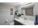 Bright bathroom featuring a dark vanity with a white countertop and a modern sink at 4705 Hollingsworth Ave, Sarasota, FL 34233