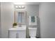 Simple bathroom featuring a white vanity, modern lighting, and gray walls at 4705 Hollingsworth Ave, Sarasota, FL 34233