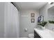 Clean bathroom offering a shower-tub combo, gray walls, and classic fixtures at 4705 Hollingsworth Ave, Sarasota, FL 34233