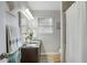 Bright bathroom featuring double sink vanity with granite countertop and walk-in shower at 4705 Hollingsworth Ave, Sarasota, FL 34233