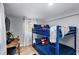 Bedroom featuring a bunk bed with nautical-themed pillows, natural light, and gray walls at 4705 Hollingsworth Ave, Sarasota, FL 34233