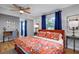 Stylish bedroom featuring hardwood floors, bright floral bedding, and a cozy study area to the left at 4705 Hollingsworth Ave, Sarasota, FL 34233